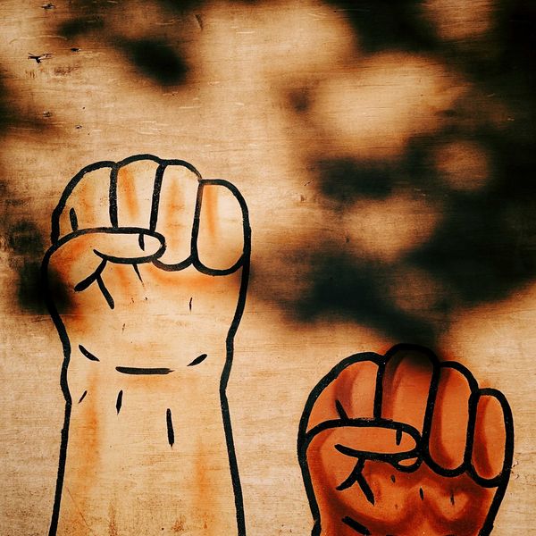 painted image of two fists clenched.