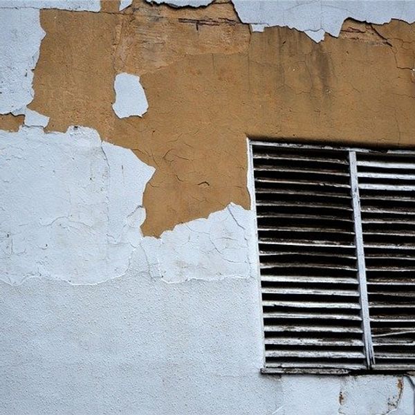 Painted wall with chipped paint.