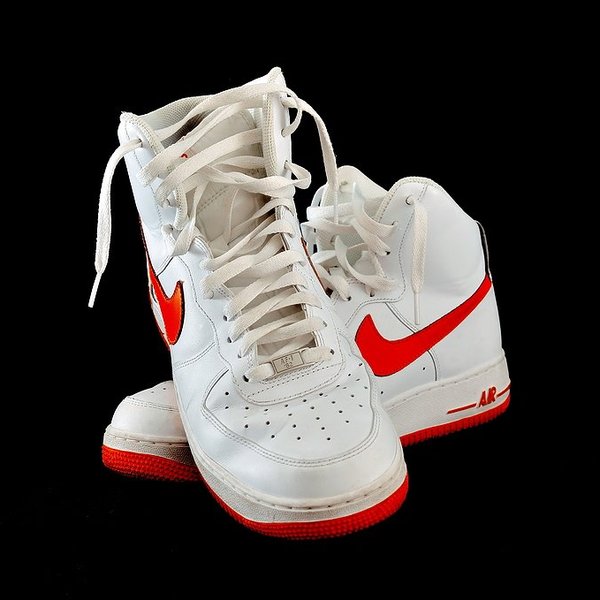 Pair of Nike sneakers, white shoes with a red swoosh