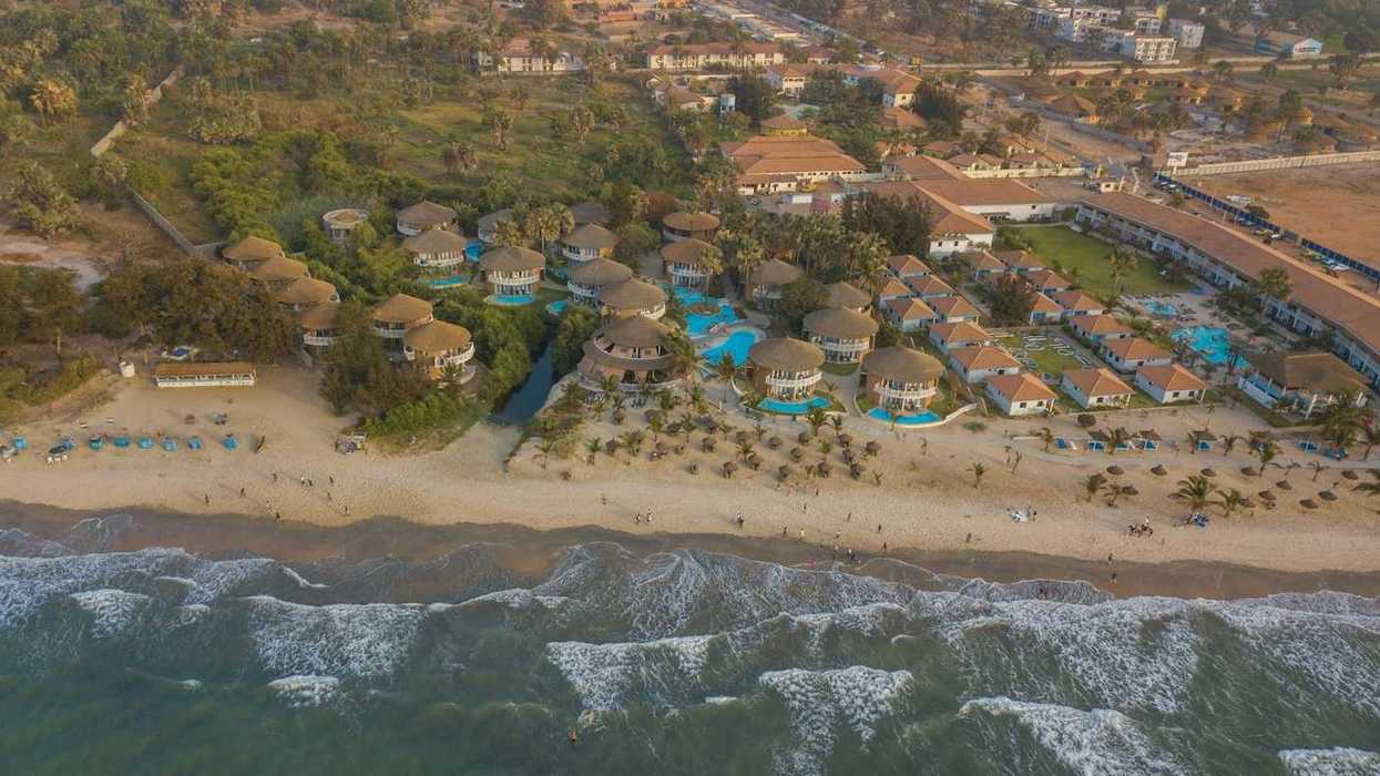 Panoramic drone view of Balafon Beach Resort on Kololi Beach in Gambia shows close proximity of ocean and inland residences