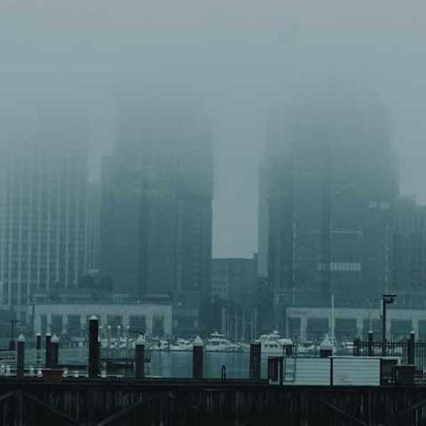 Part of a city skyline covered in haze