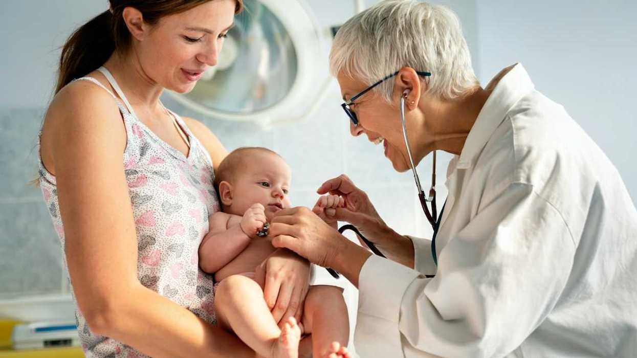 Pediatrician with mother and baby