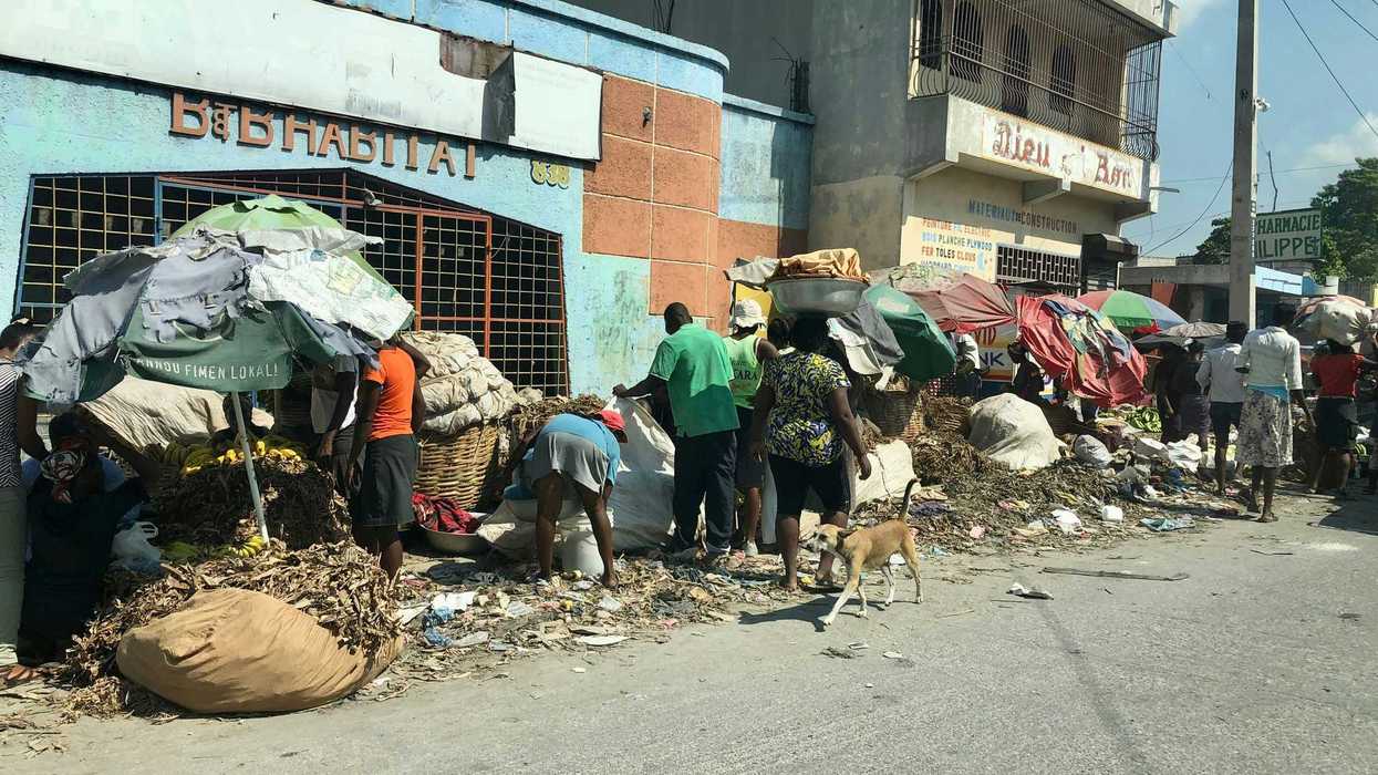 people on road beside building.