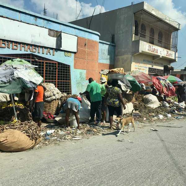 people on road beside building.
