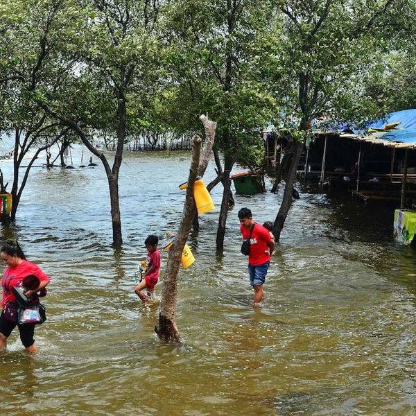 people wading through floodwaters