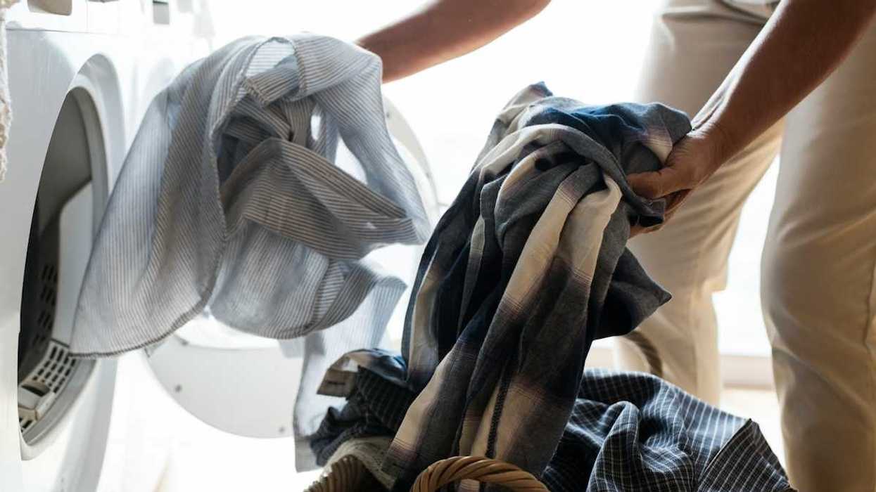 Person switching laundry - either loading or unloading