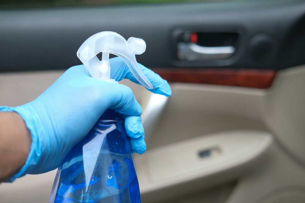 person wearing gloves with spray bottle