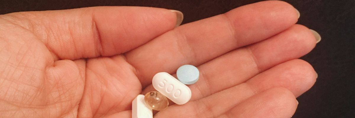 person woman holds a handful of supplements