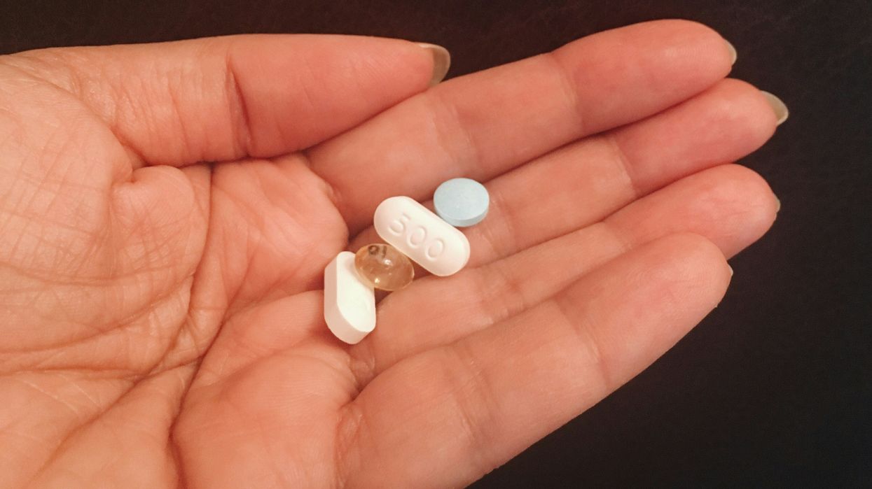 person woman holds a handful of supplements