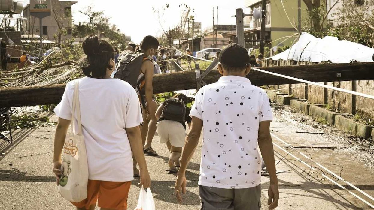 Philippines typhoon survivors walking in storm aftermath