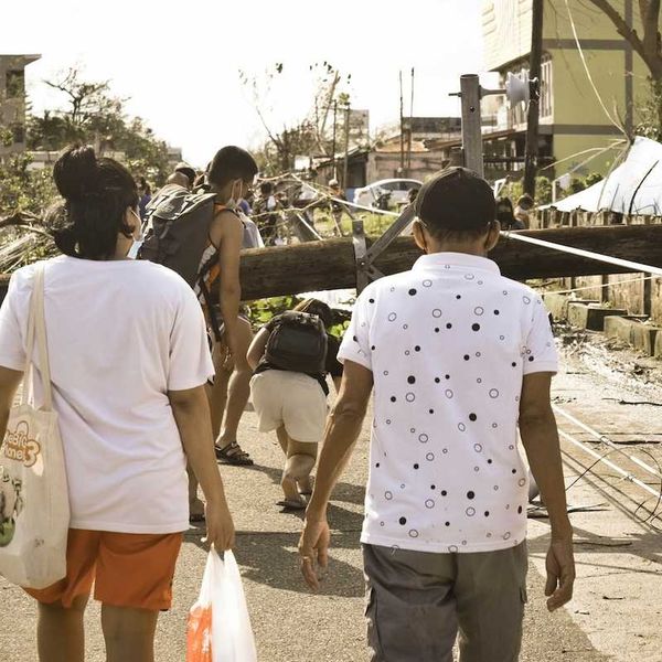 Philippines typhoon survivors walking in storm aftermath