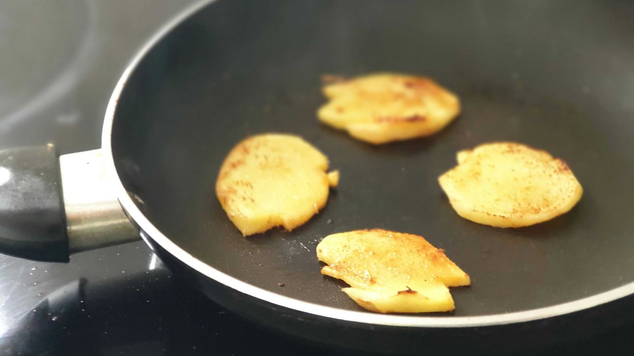 Pieces of ginger fying in a nonstick pan