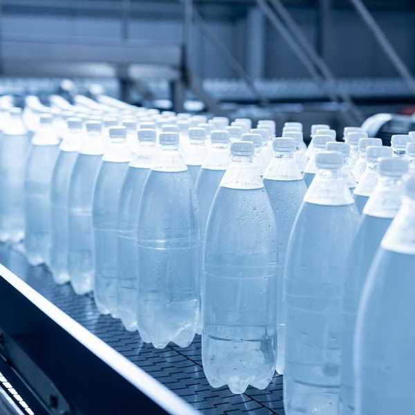 Plastic beverage bottles on an assembly line conveyor