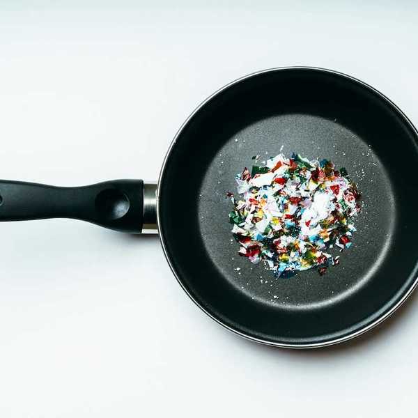 Plastic pieces displayed in a coated frying pan indicative of pyrolysis