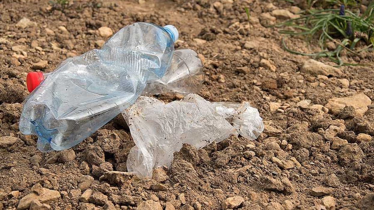 Plastic trash sitting on dirt