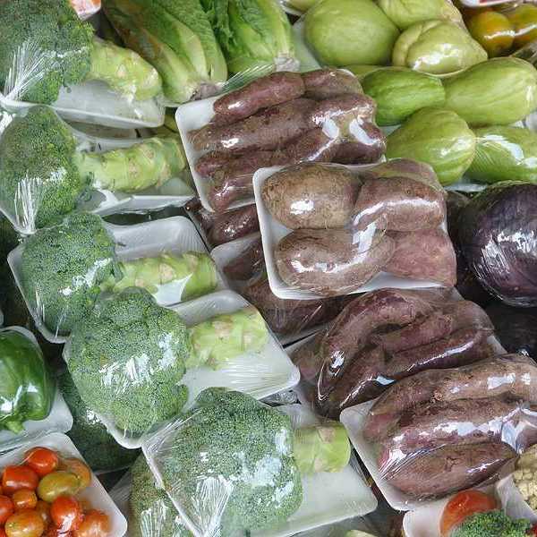 Plastic wrapped vegetables in a grocery store