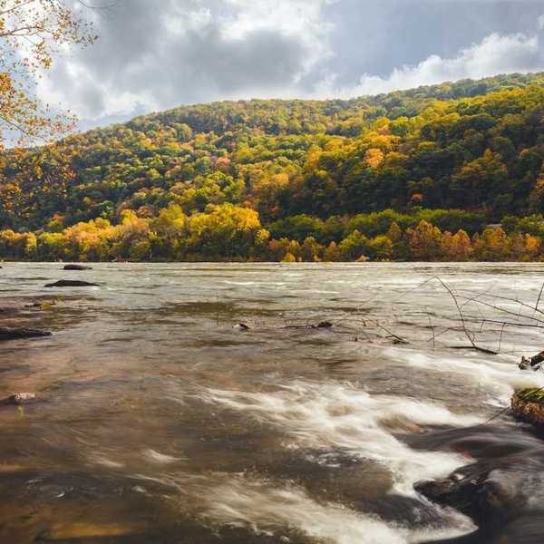Potomac river flowing through West Virginia amidst foliage-studded hills
