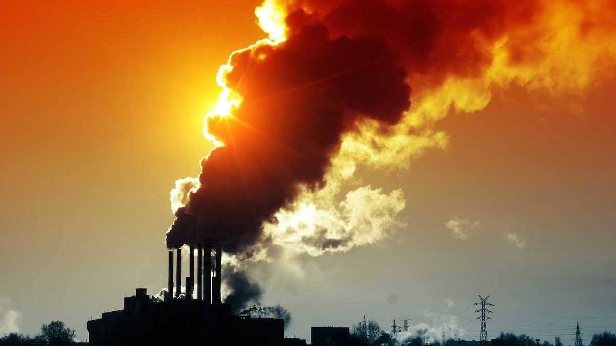 Power plant spewing smoke and dirty orange air
