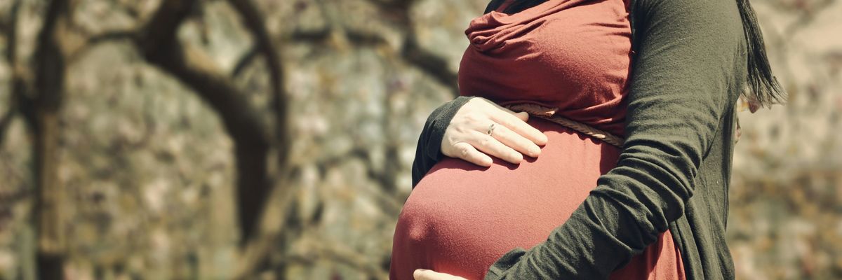 pregnant woman holding her stomach