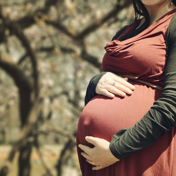 pregnant woman holding her stomach