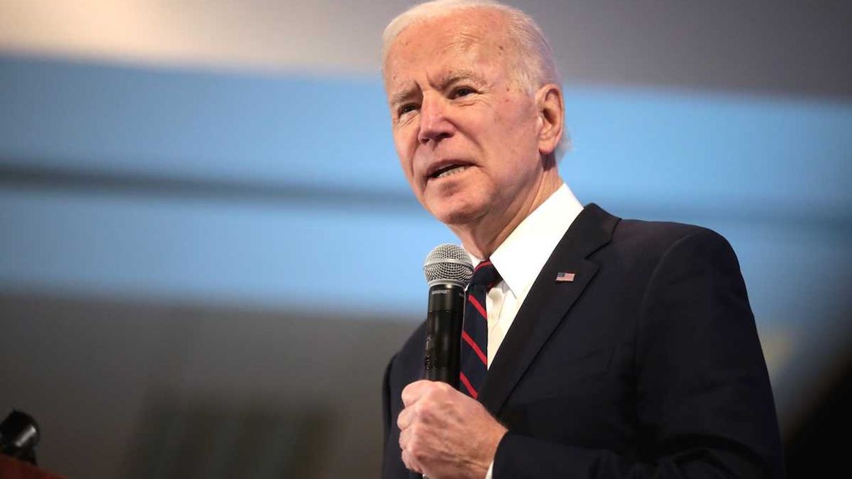 President Joe Biden speaking while holding a microphone