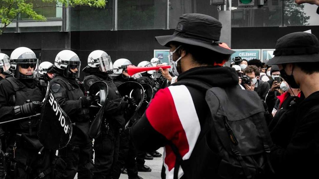 Protesters face of with police on city street