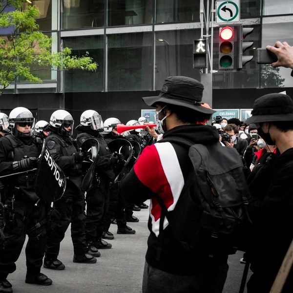 Protesters face of with police on city street