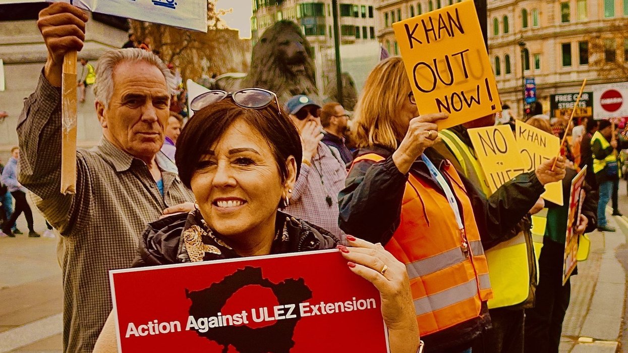 Protesters hold signs resisting London's ultra low emissions zones, or ULEZ.