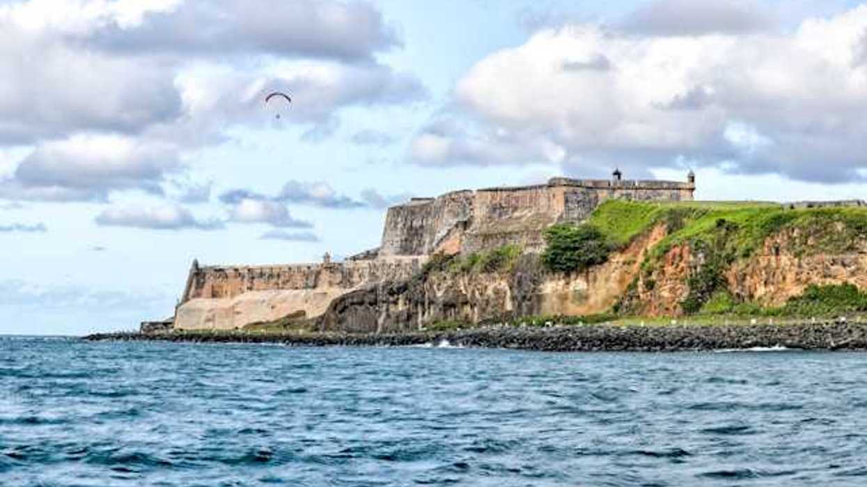 Puerto Rico's coastline with buildings that are ruins in the distance