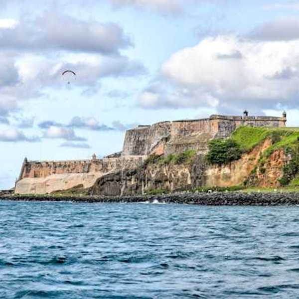Puerto Rico's coastline with buildings that are ruins in the distance