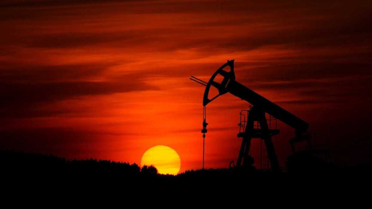 Pump-jack mining crude oil against the sunset