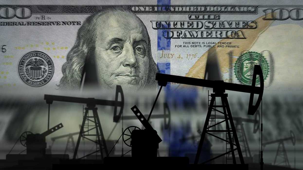 Pumpjacks and fuel business superimposed on US one hundred dollar bank note.