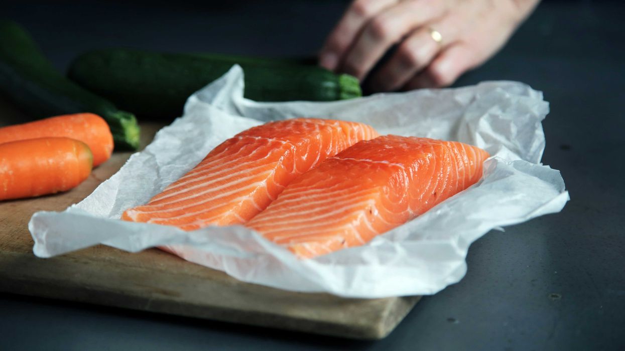 raw salmon on brown chopping board