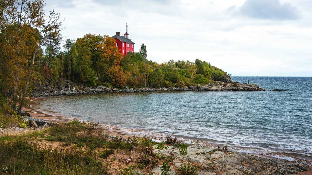red and white building near body of water during daytime
