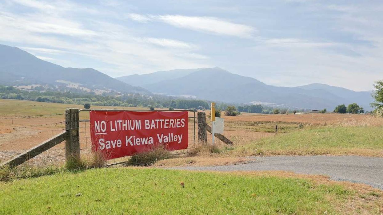 Red banner on fence reading " No lithium batteries Save Kiewa Valley"