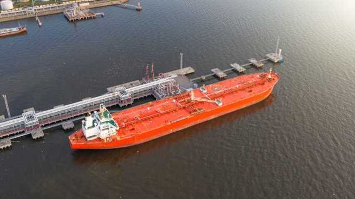 Red oil tanker at a dock