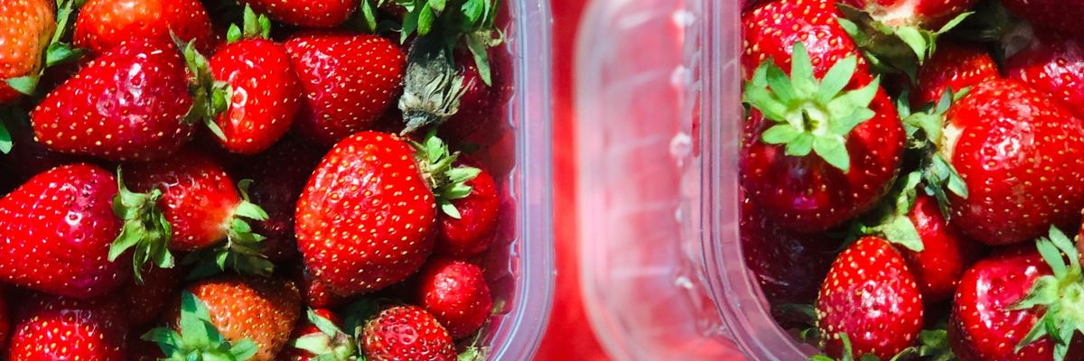 red strawberries in clear plastic container