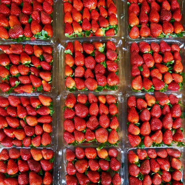 red strawberries in clear plastic containers
