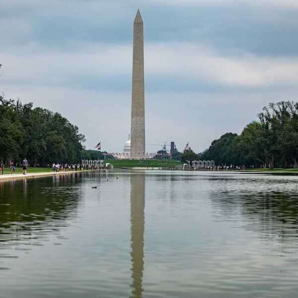 Reflecting pool on national mall with Washington monument and Capitol building behind