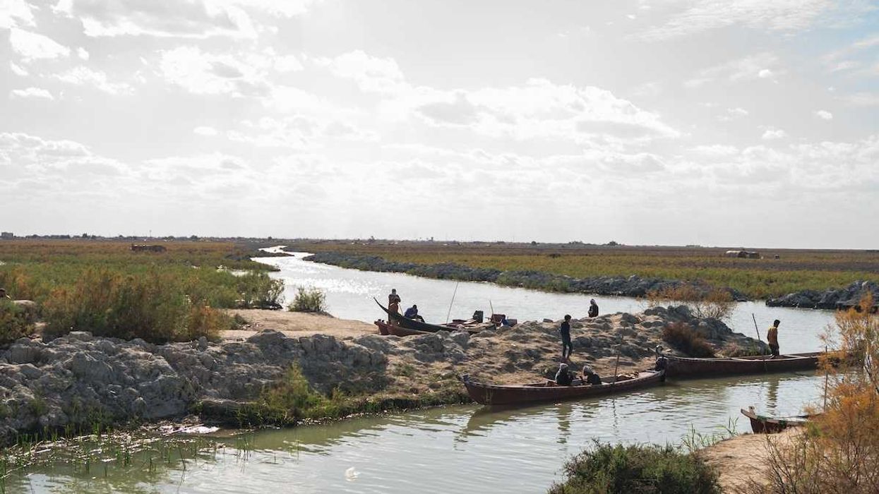 River in Iraq with boats and boatmen