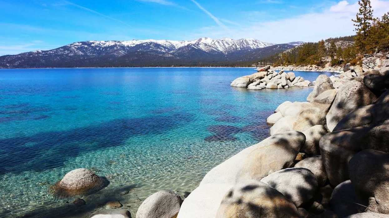 Rocky shoreline of Lake Tahoe with snow-capped Sierras in the background