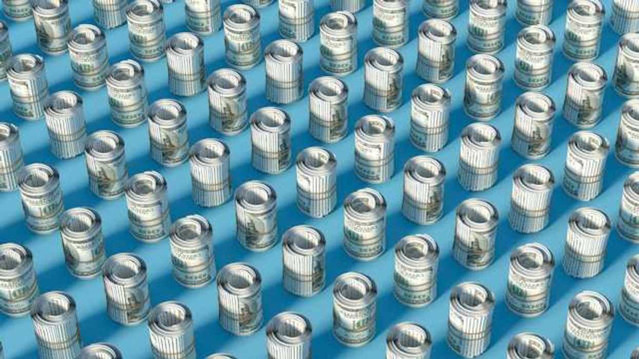 Rows of rolled up hundred-dollar U.S. bills on a blue surface