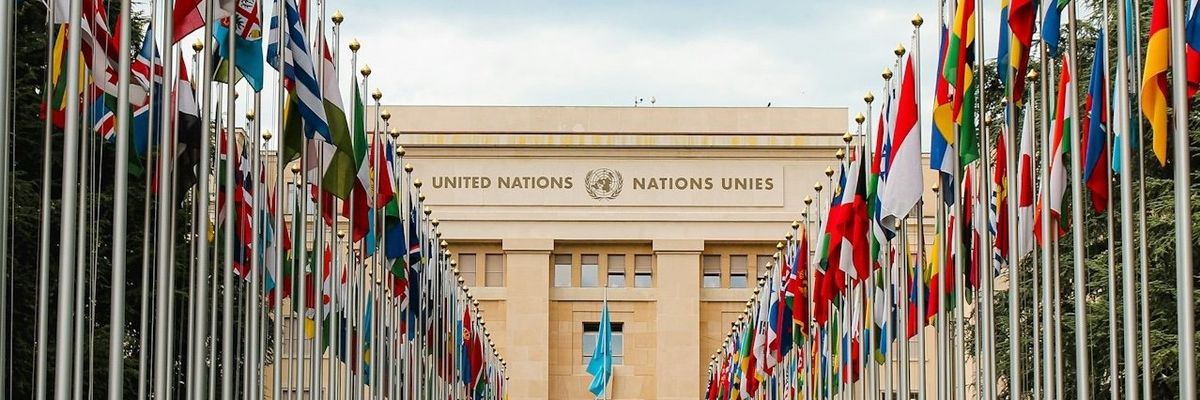 Rows of United Nations world flags outside UN building in Geneva, Switzerland.