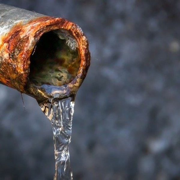 rusty pipe with water coming out