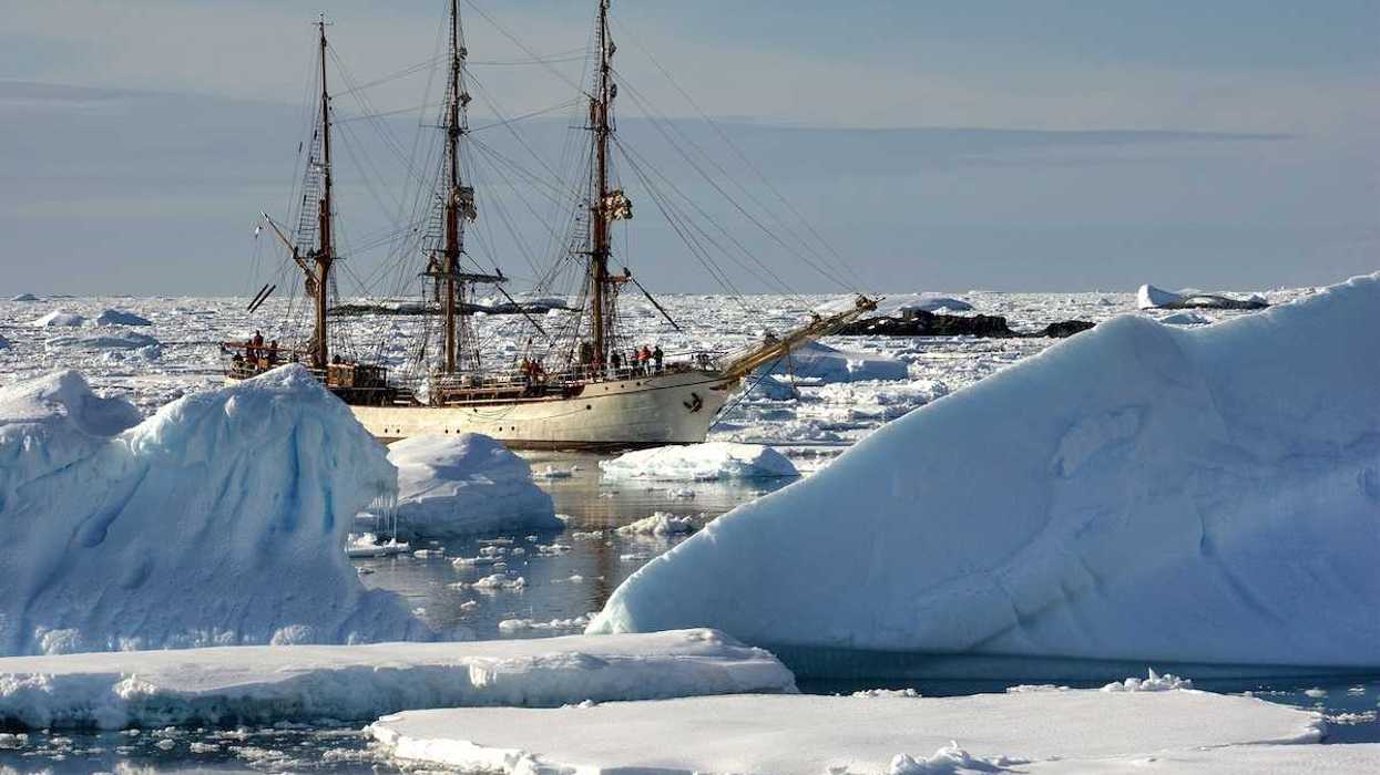 Sailing ship among the icebergs, Antarctica