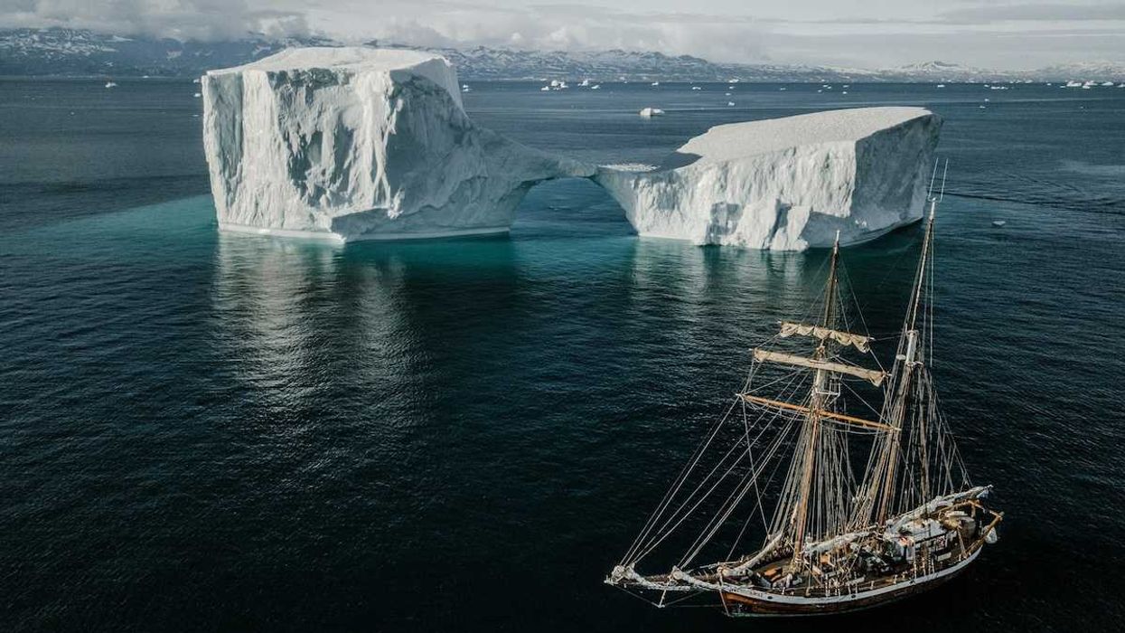 Sailing vessel navigating icebergs in Arctic waters