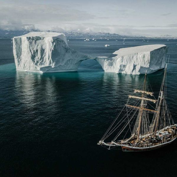 Sailing vessel navigating icebergs in Arctic waters