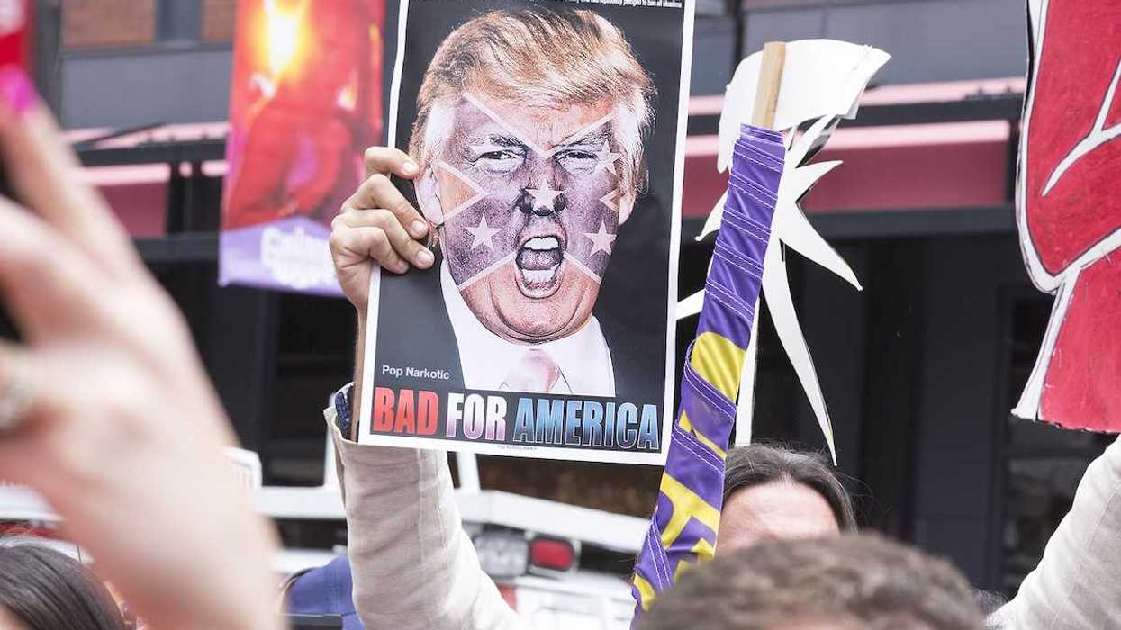 SAN DIEGO USA - MAY 27 2016: A protester holds a sign featuring an angry photo of Donald Trump and reading "Bad for America" at an anti-Trump protest outside a Trump rally in San Diego.