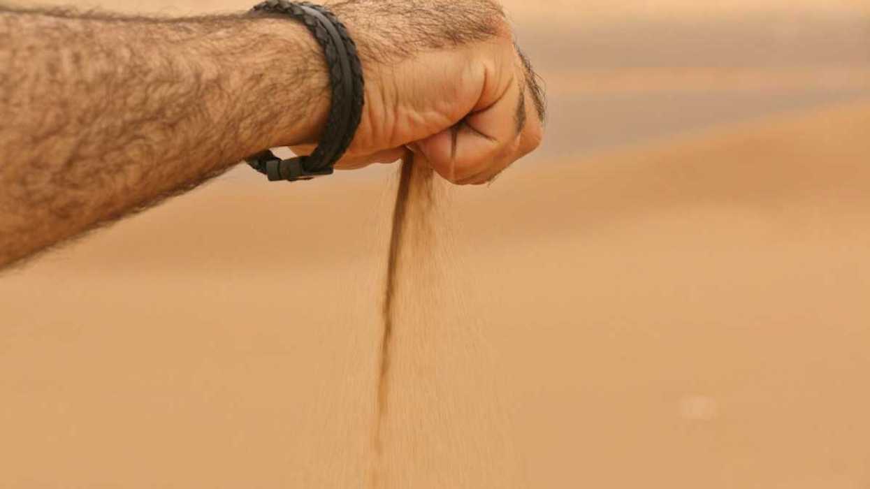Sand sifting slowly through clenched hand.