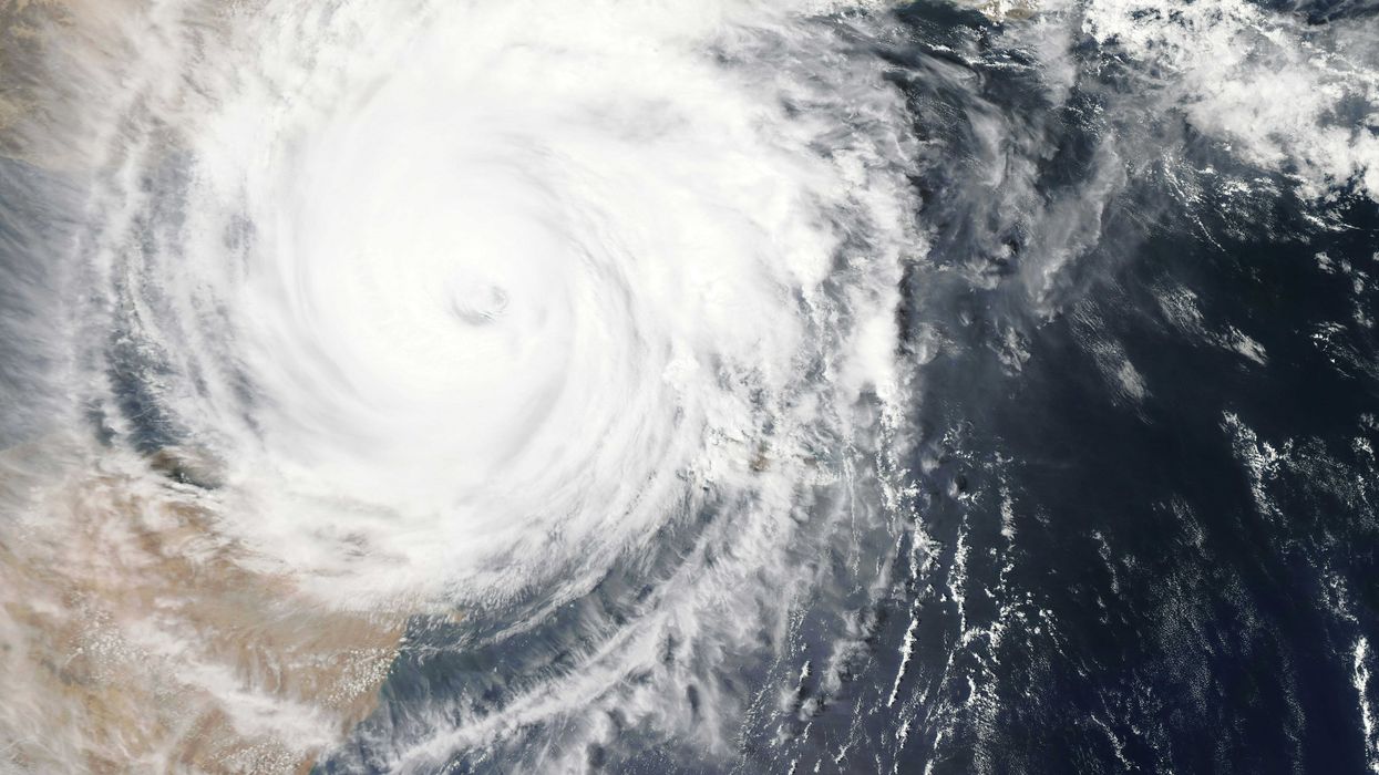 satellite image of a hurricane over land and sea.